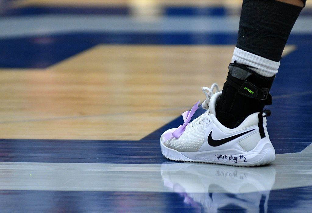 Erika Miller plays with a message honoring Shelby Meyer written onto her shoe